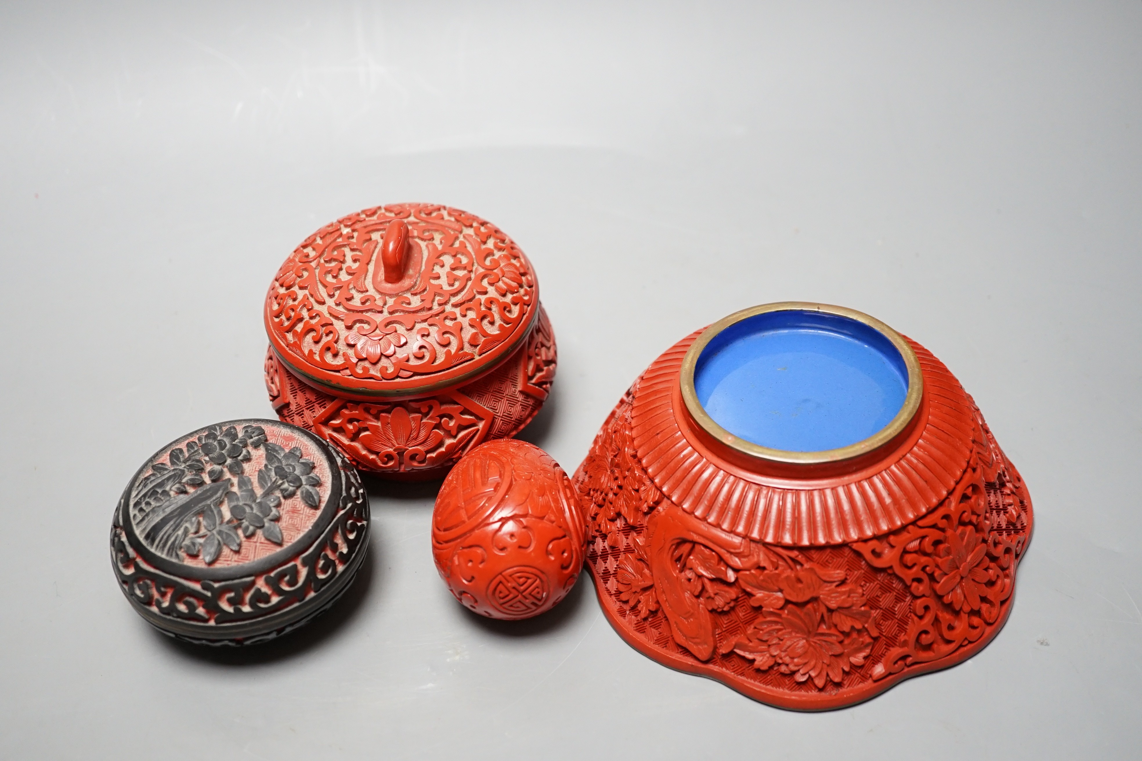 A Chinese cinnabar lacquer bowl, a similar covered box and egg, and a carved circular box and cover